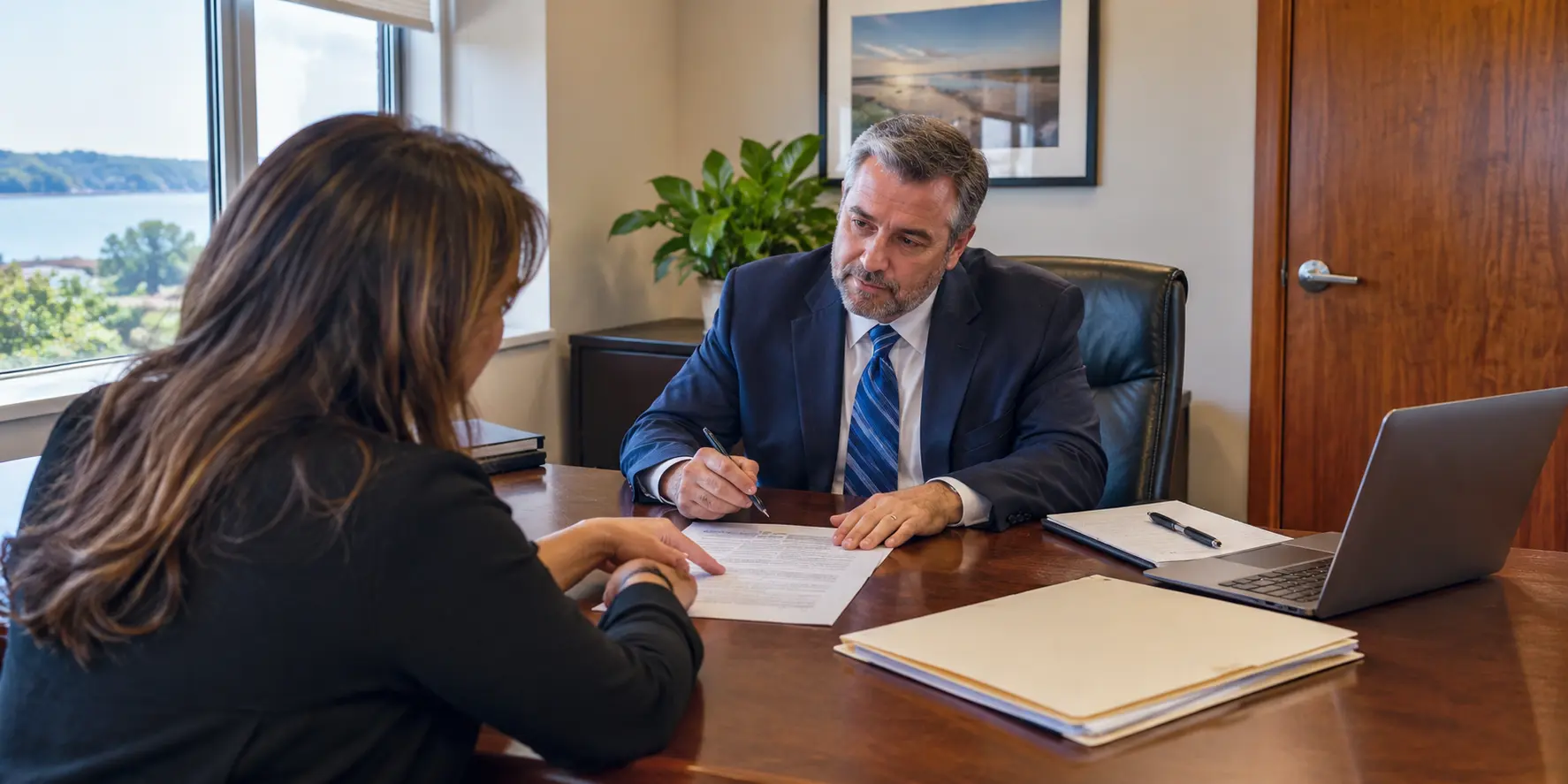 Attorney and prospective client discussing confidentiality during legal consultations in a private law office.